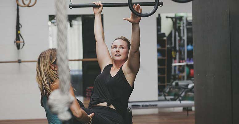 Woman excersing in a wheelchair in a gym